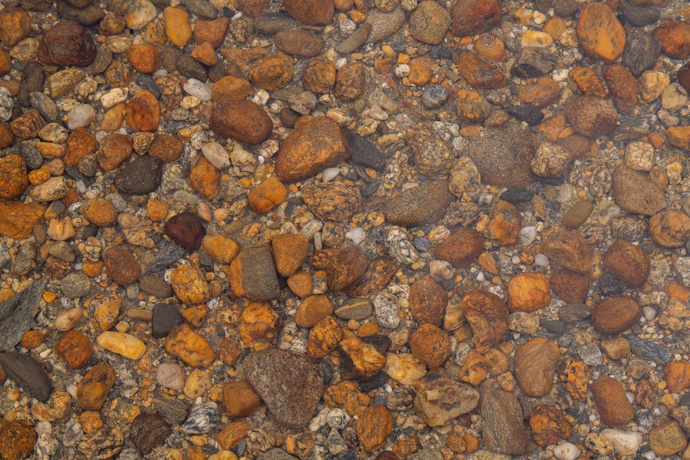 Orange and brown river gravel seen close up
