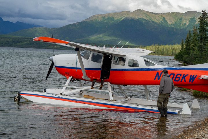 A floatplane pulled up on a lakeshore