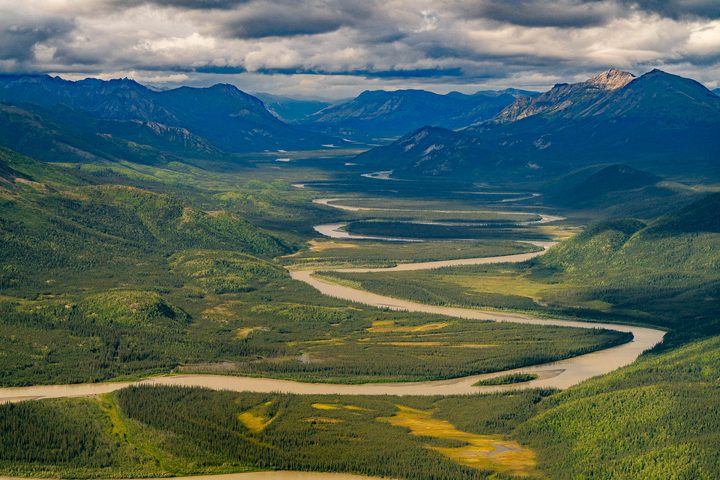 A braided river winding through a valley with no road, no structure and no cut in it