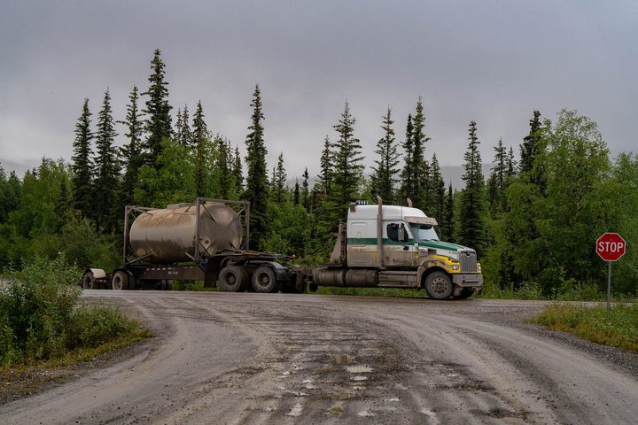 A tanker pulling onto the gravel haul road