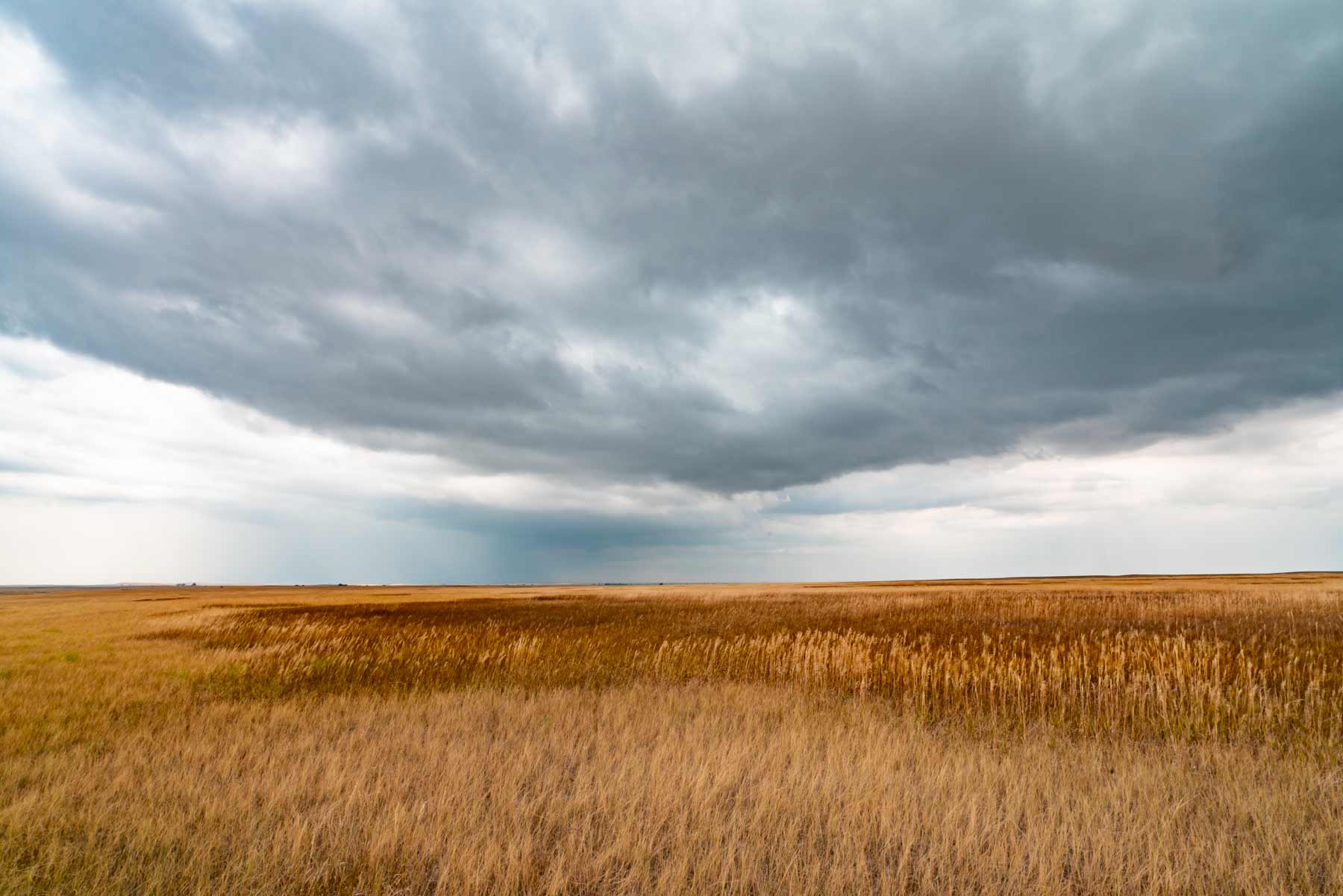 Storm over prairie grassland, Badlands country, South Dakota