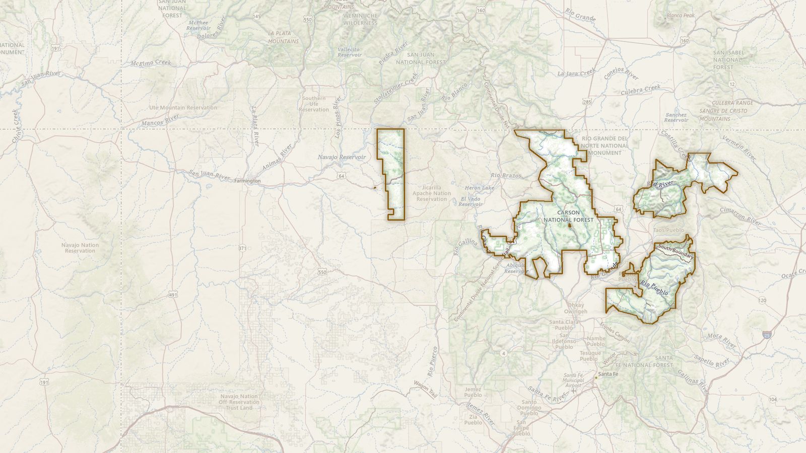 The boundary of the Carson National Forest drawn on the USGS topographic map, with the towns, highways and rivers around it.