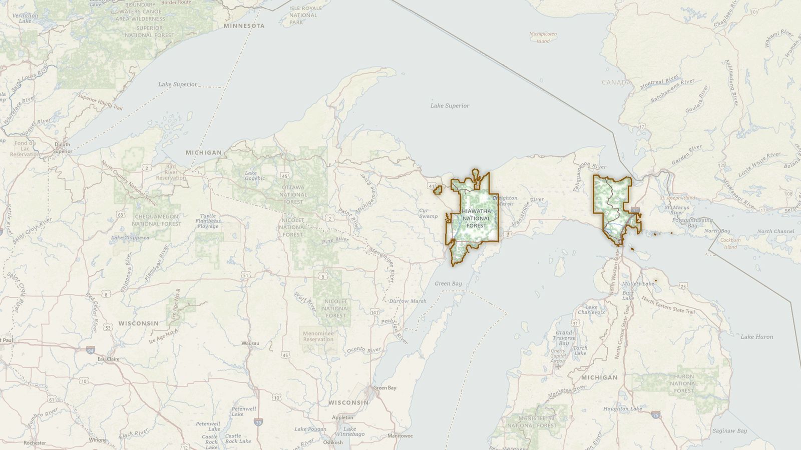 The boundary of the Hiawatha National Forest drawn on the USGS topographic map, with the towns, highways and rivers around it.