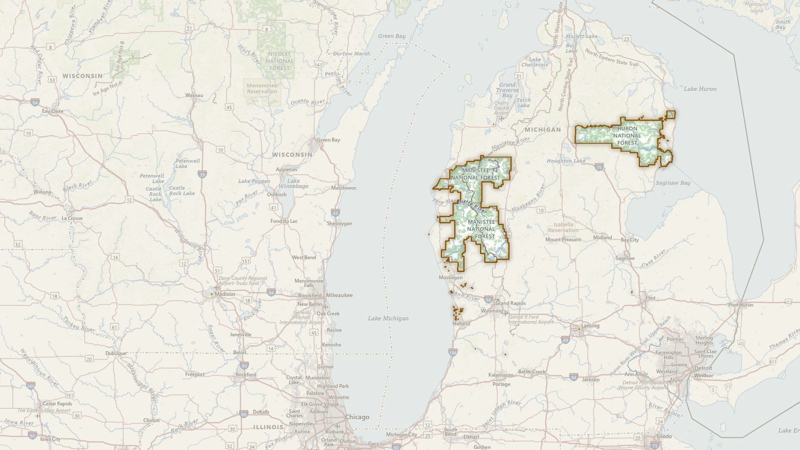The boundary of the Huron-Manistee National Forest drawn on the USGS topographic map, with the towns, highways and rivers around it.