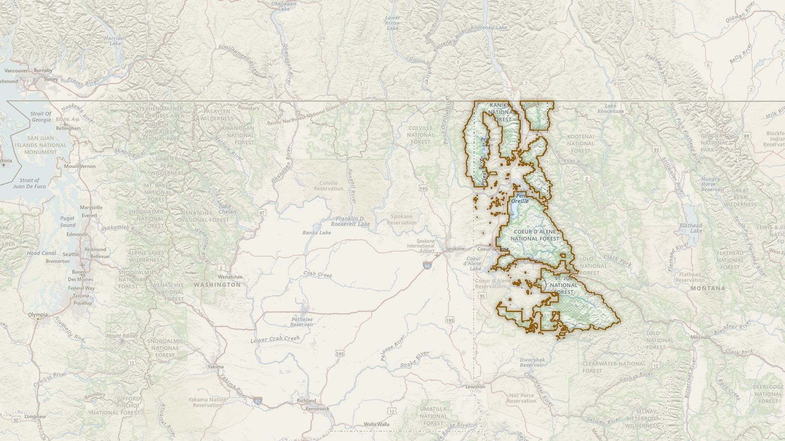 The boundary of the Idaho Panhandle National Forests drawn on the USGS topographic map, with the towns, highways and rivers around it.