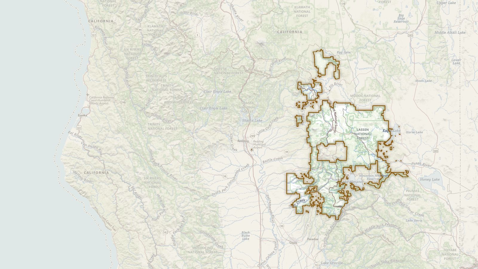 The boundary of the Lassen National Forest drawn on the USGS topographic map, with the towns, highways and rivers around it.