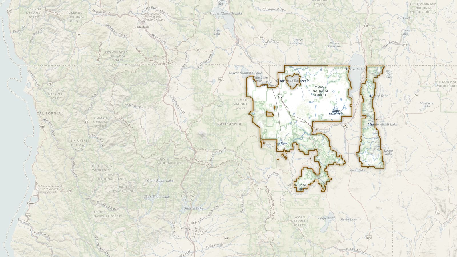The boundary of the Modoc National Forest drawn on the USGS topographic map, with the towns, highways and rivers around it.