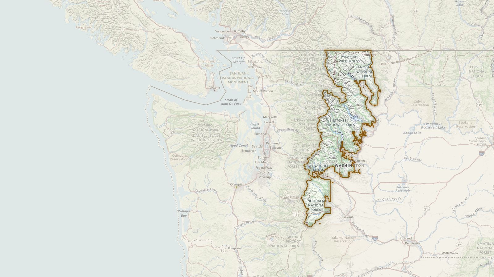 The boundary of the Okanogan-Wenatchee National Forest drawn on the USGS topographic map, with the towns, highways and rivers around it.