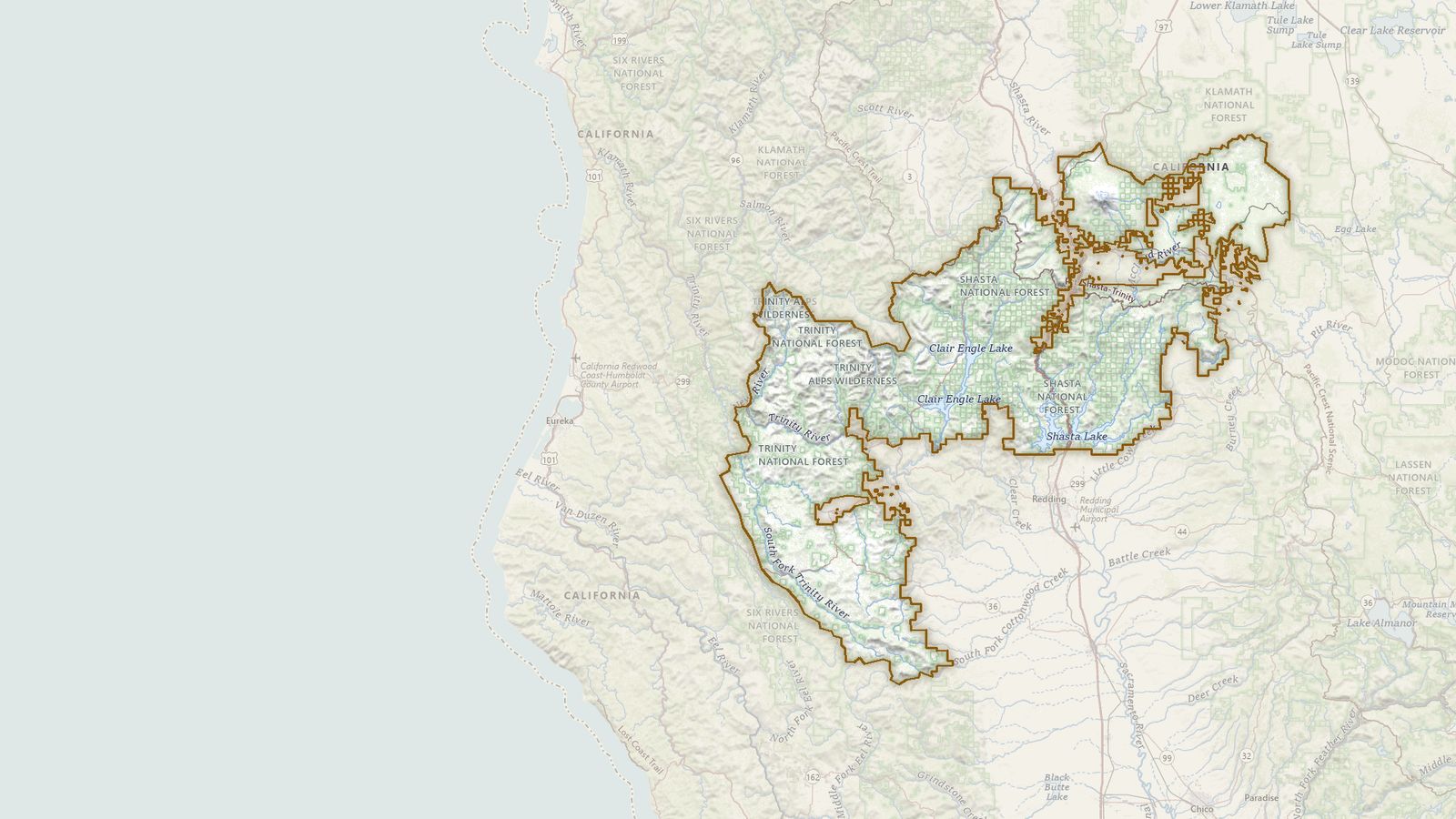 The boundary of the Shasta-Trinity National Forest drawn on the USGS topographic map, with the towns, highways and rivers around it.