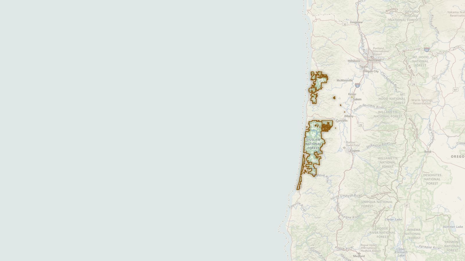 The boundary of the Siuslaw National Forest drawn on the USGS topographic map, with the towns, highways and rivers around it.