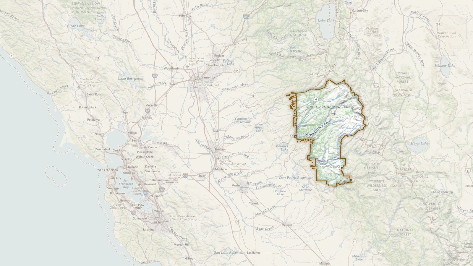 The boundary of the Stanislaus National Forest drawn on the USGS topographic map, with the towns, highways and rivers around it.