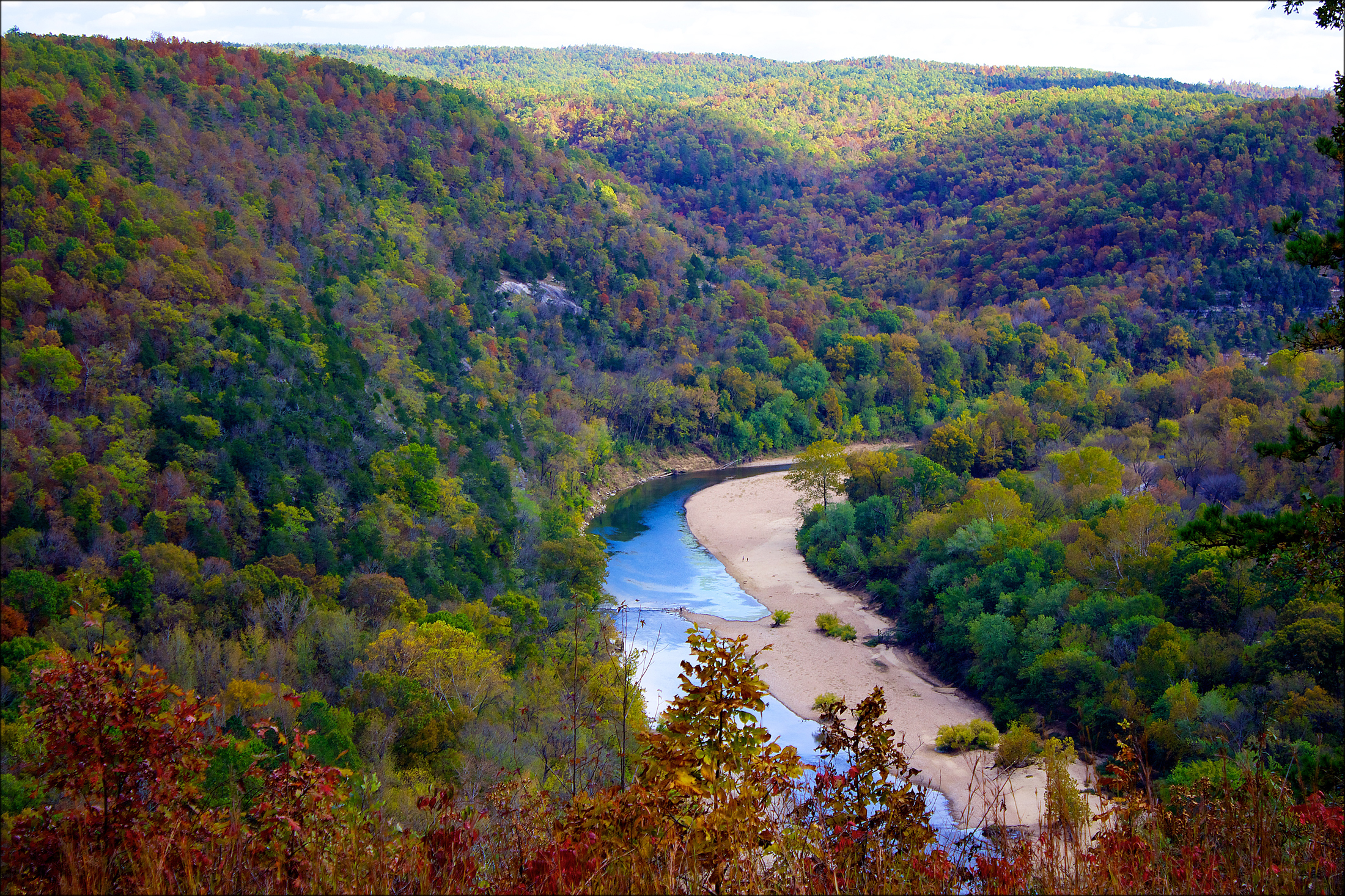 Buffalo River goes through the center of the photo will fall foliage creating an explosive burst of color around it on rolling hills.