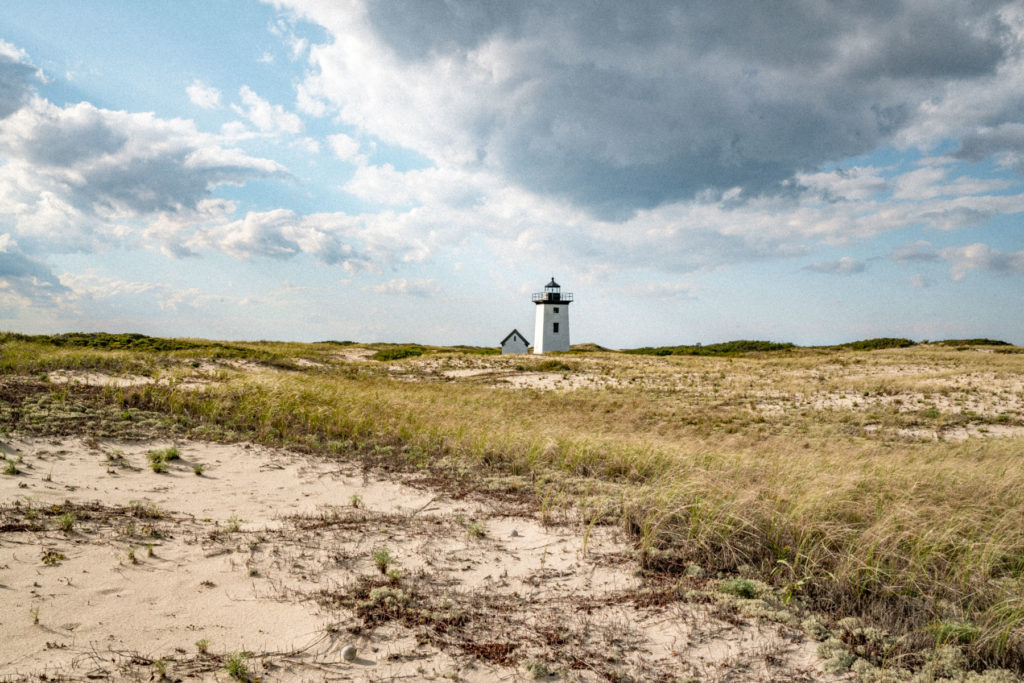 Wood End light across the dunes.