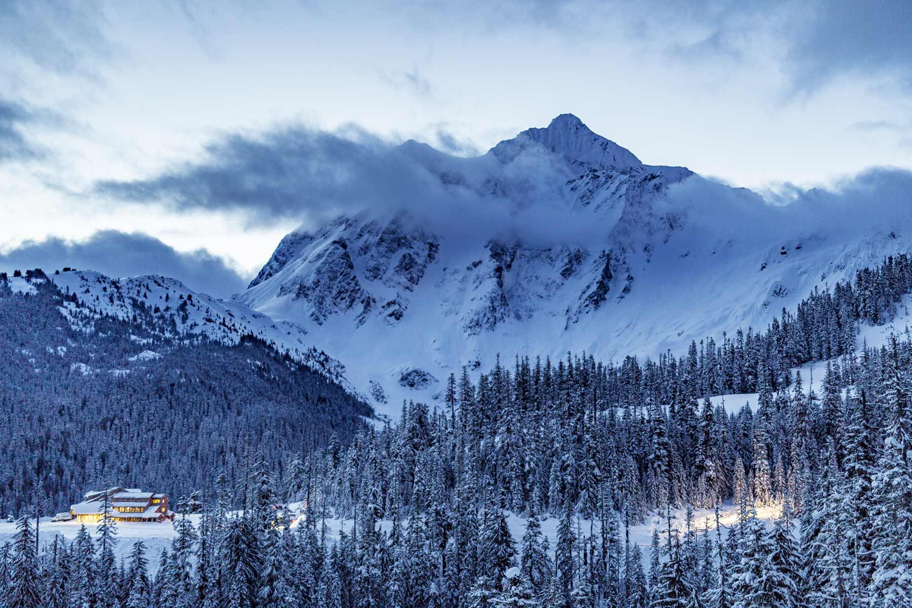 Mount Shuksan under fresh snow above a snowy forest in the North Cascades