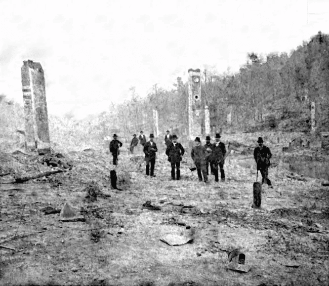 Several men standing in the aftermath of the 1878 Downtown Hot Springs fire 