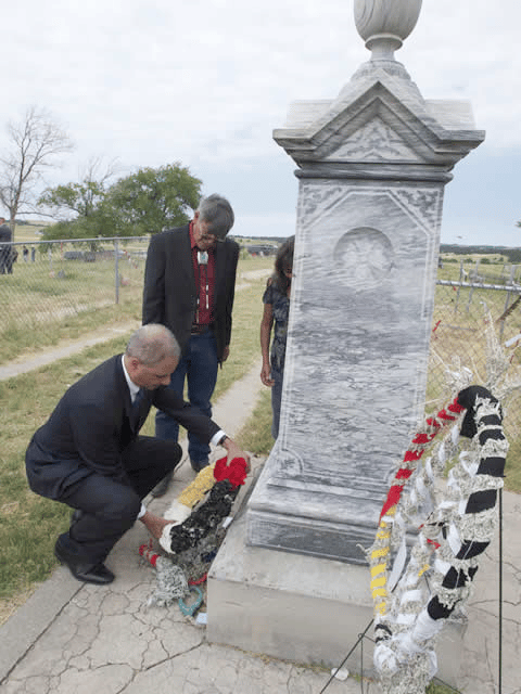 U.S. Attorney General Eric Holder laying a wreath at the site of the Wounded Knee Memorial