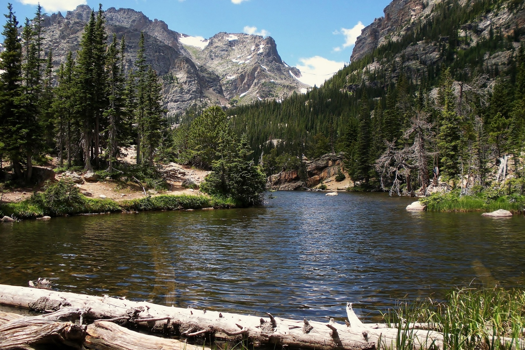 The Loch lake surrounded by mountains and pines in Rocky Mountain National Park.