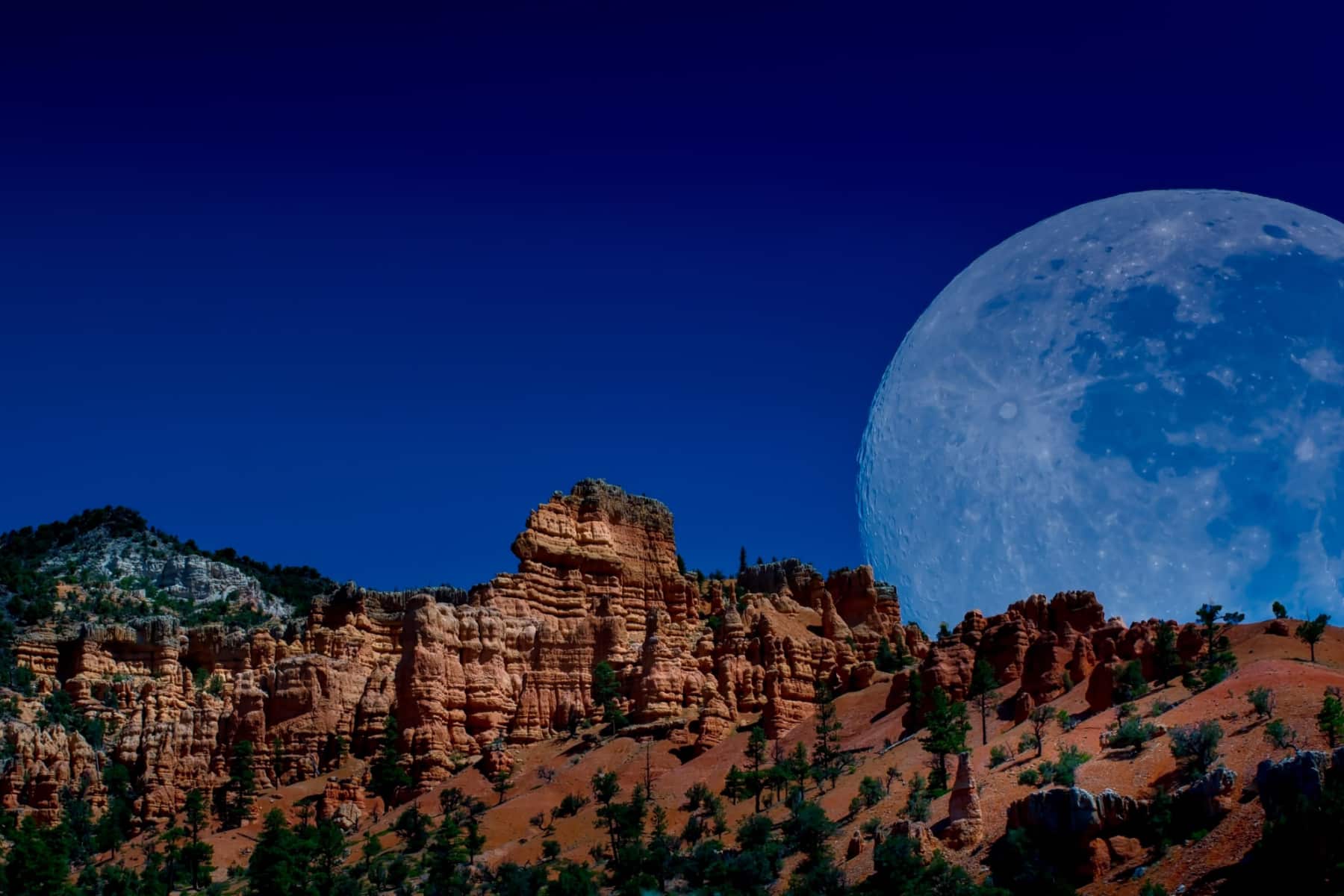 Full moon rising over rocky ledge at Bryce Canyon National Park. 