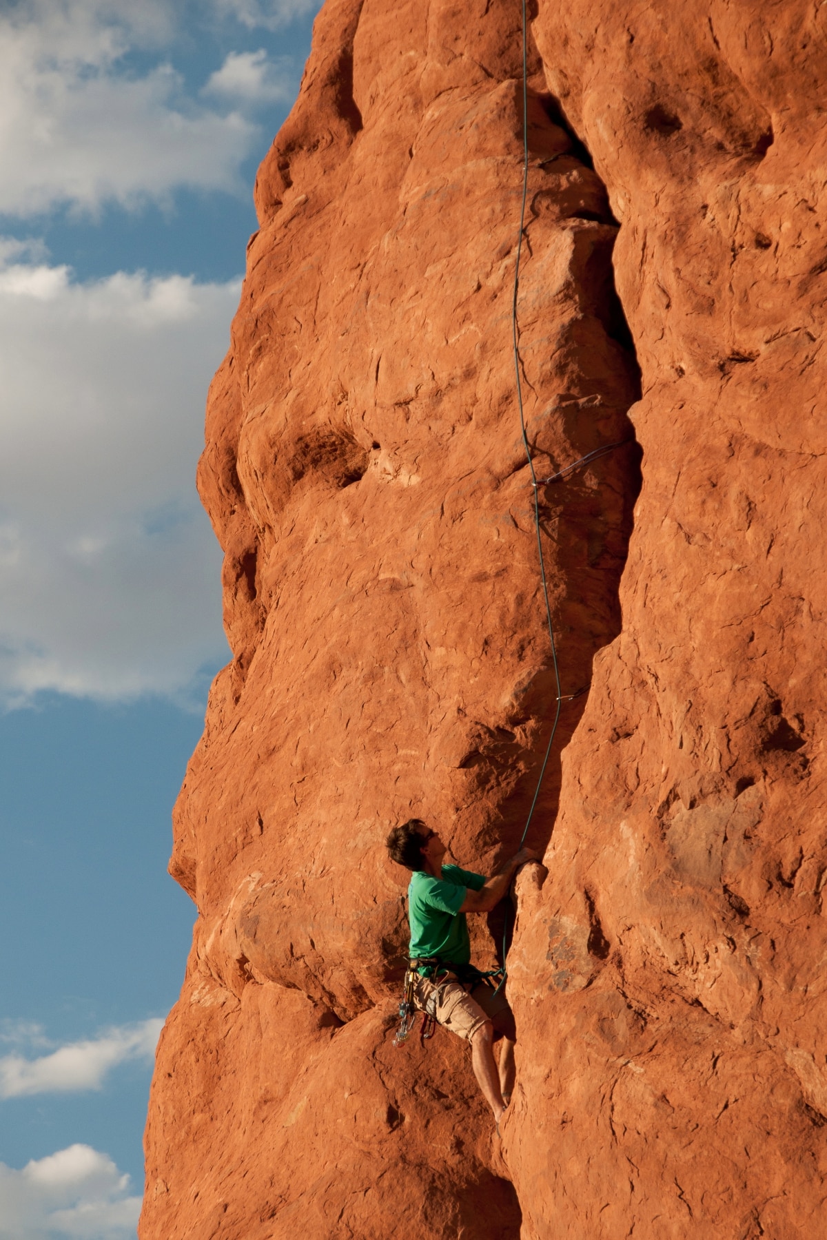 A climber on a sandstone wall at Arches National Park. 