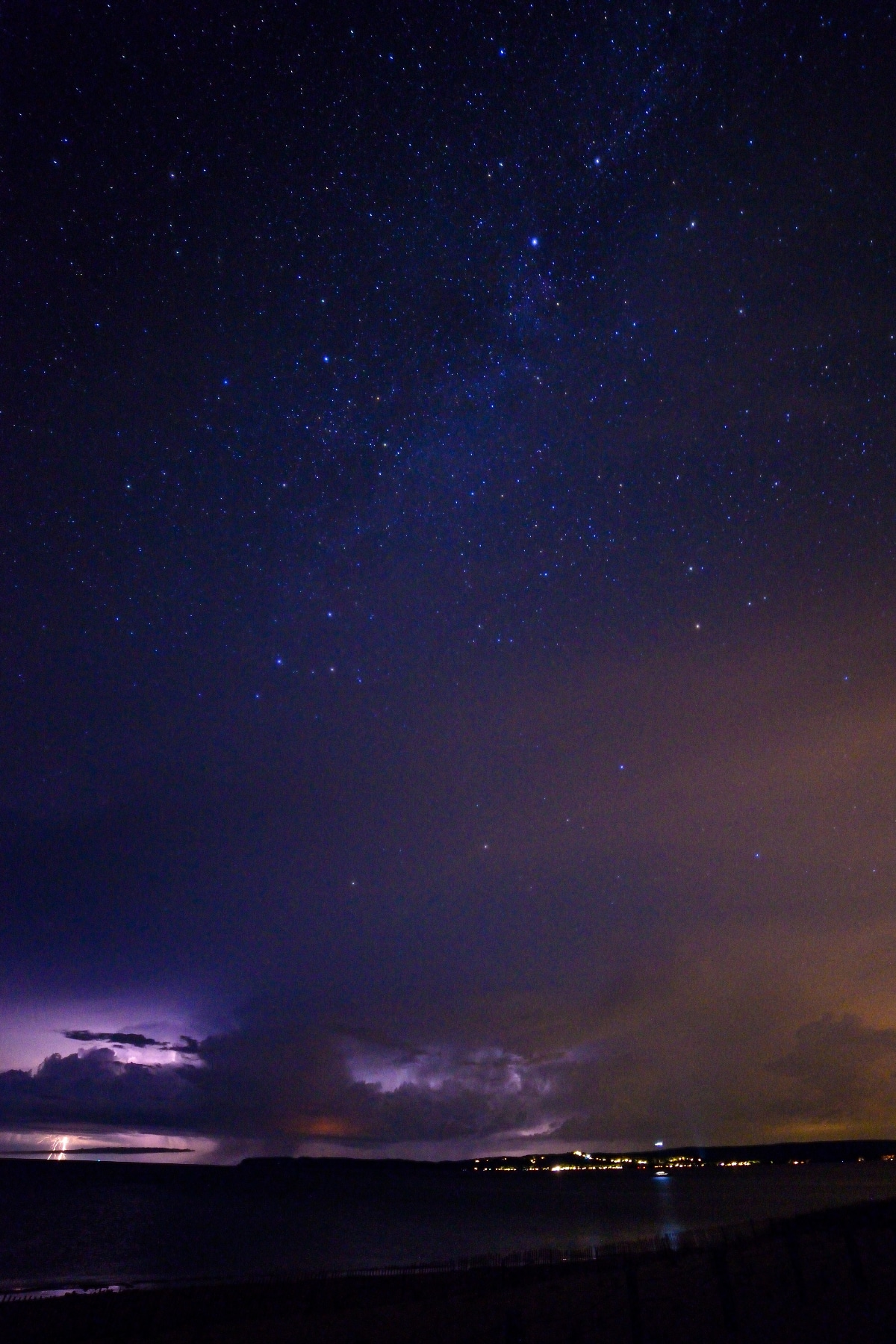 Storm clouds and night skies above a lake in Michigan.