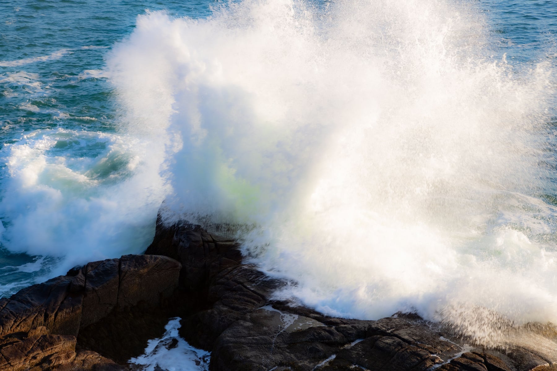 A giant wave crashes at Otter Cliffs in Acadia National Park. 