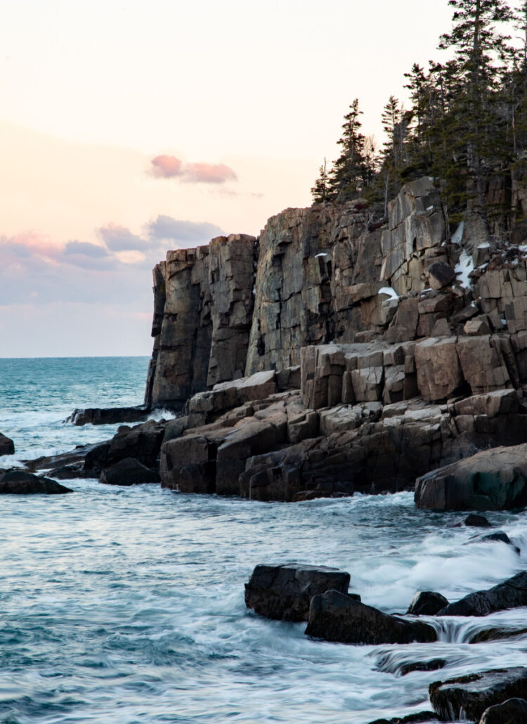 Otter Cliffs in Acadia National Park with snow on the ledges.