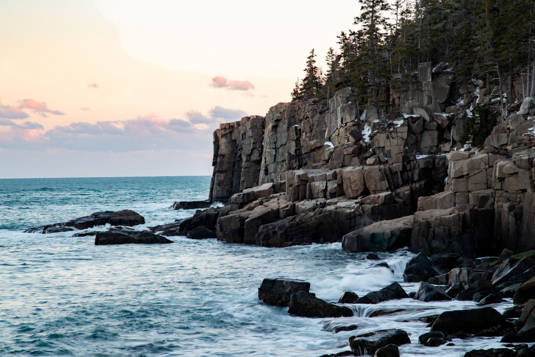 Otter Cliffs in Acadia National Park with snow on the ledges.