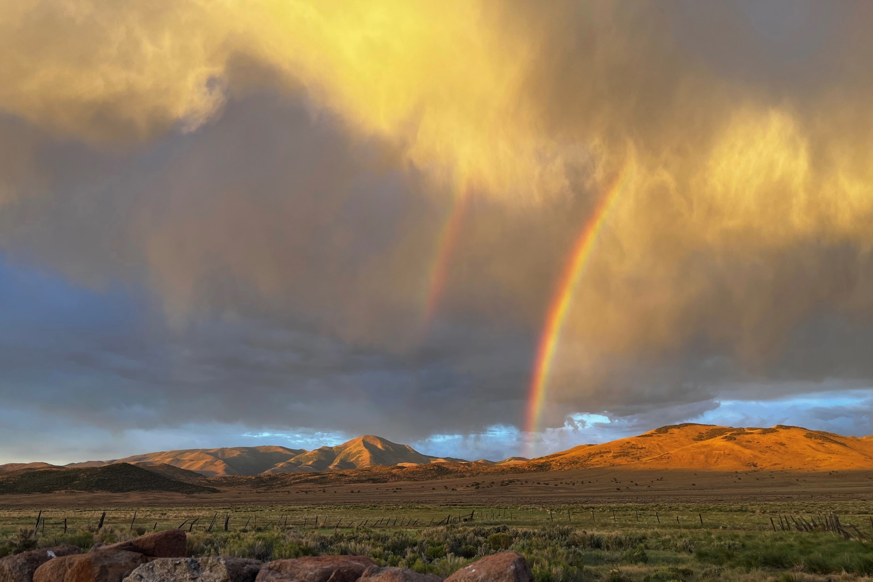 Rainbow over the desert terrain in Nevada wilderness.