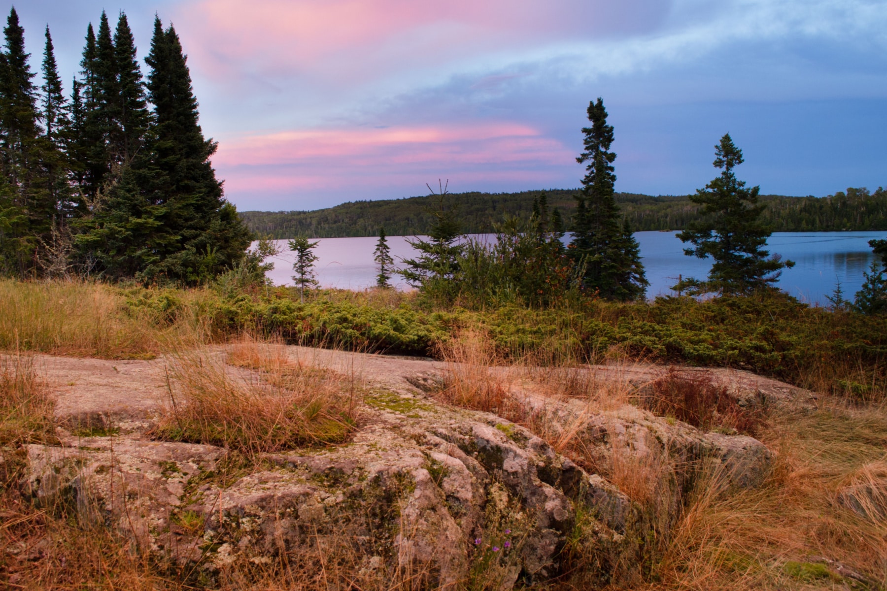 A pink and blue hued sky during a sunset at Isle Royale National Park. 