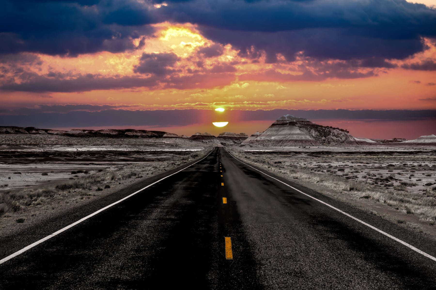 The sunset over the road through Petrified Forest National Park.