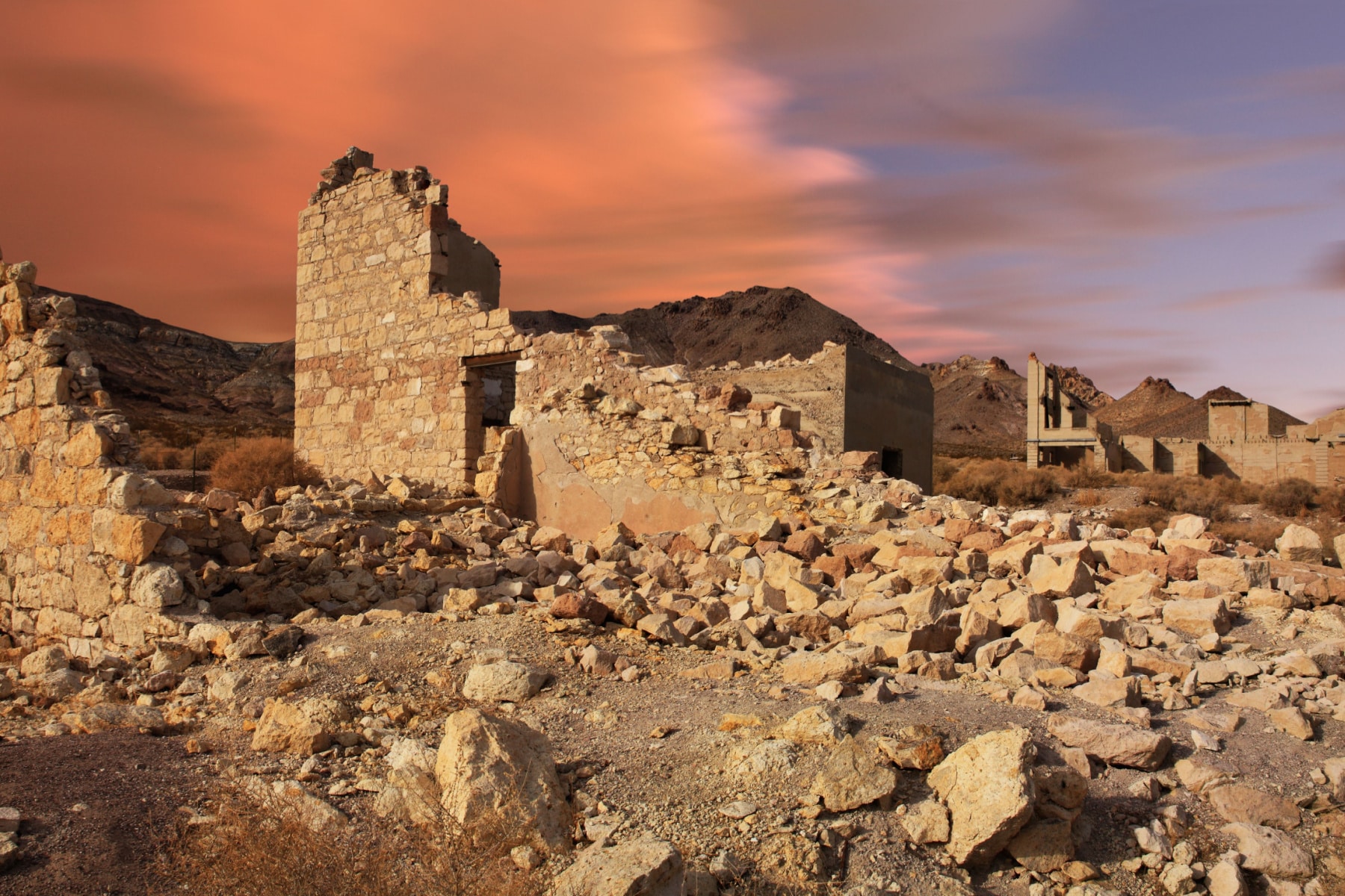 Rhyolite Nevada ghost town in Nye County, with buildings crumbling down the hill along the dark sky park road trip.