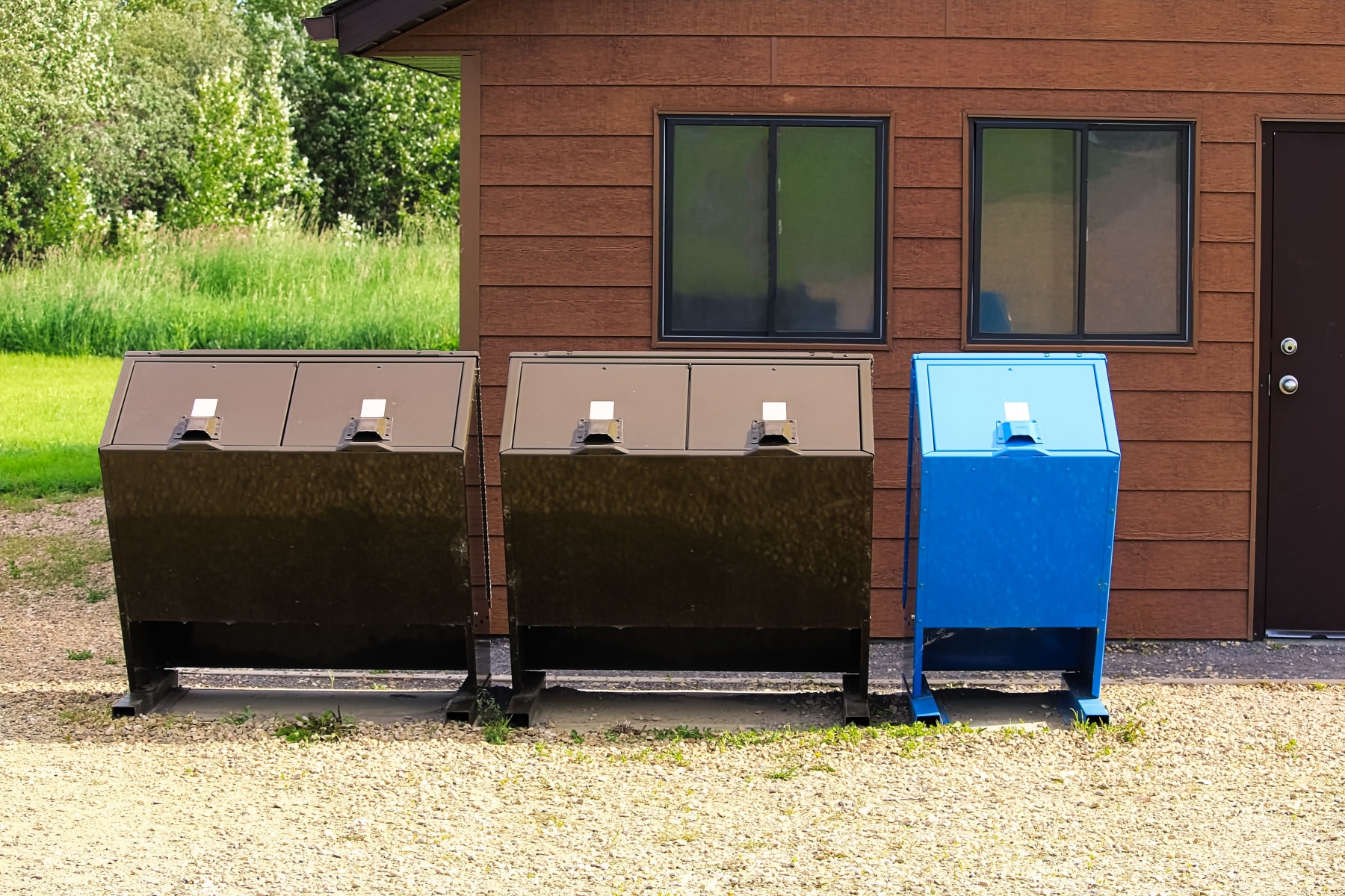 Two brown and one blue bear proof bin bins. 