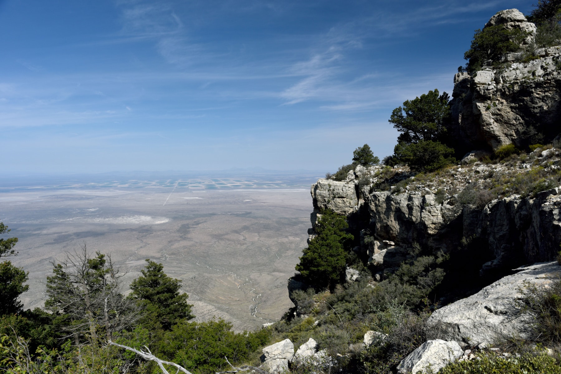 A view from the Bush Mountain Trail in Guadalupe Mountains National park shows the steep views and distant agricultural land of West Texas.