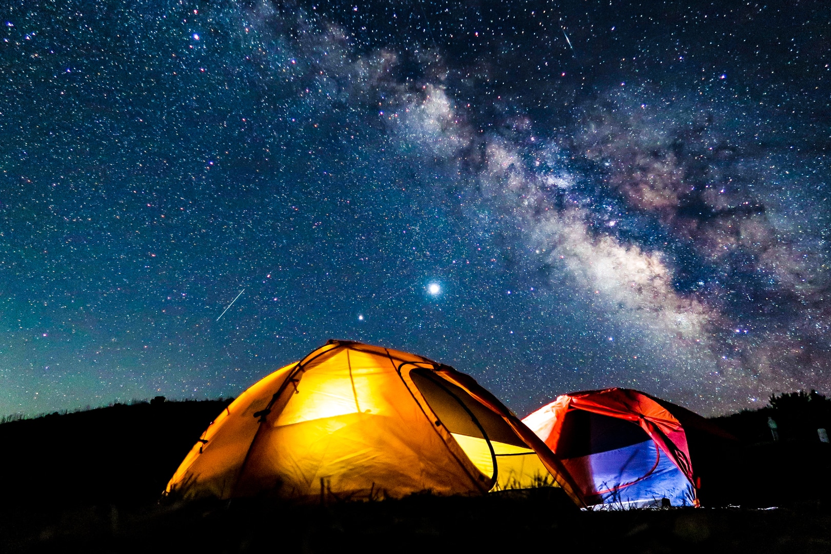 Two tents under the Milky Way at a backcountry campsite, one of the best Channel Islands National Park things to do. 